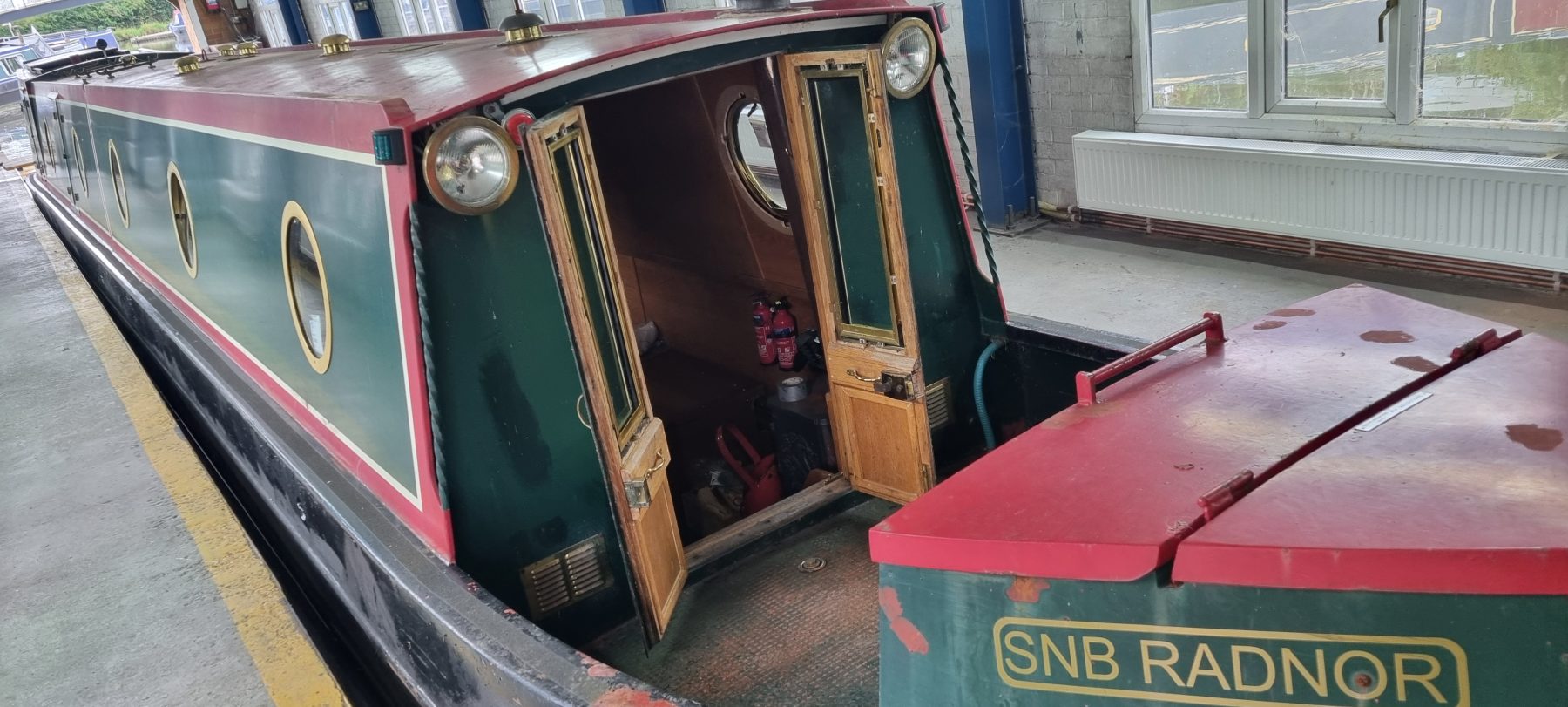 A narrowboat inside the covered wet dock